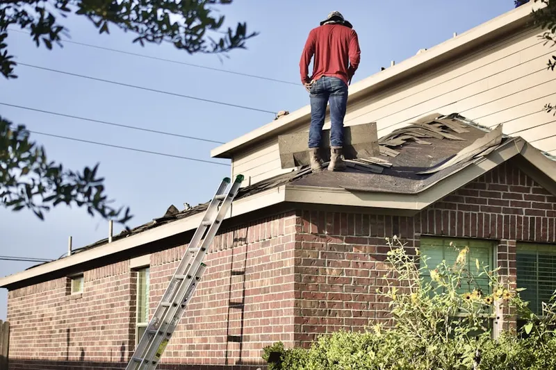 Professional roofer working on a residential roof in North Grapeland Heights